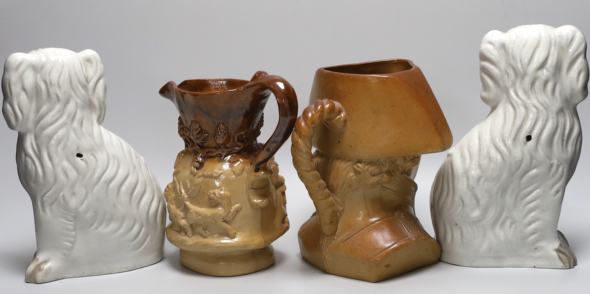 A Doulton and Watts glazed stoneware bust of Lord Nelson, a pair of white glazed Staffordshire pottery dogs and a Victorian earthenware jug (4)